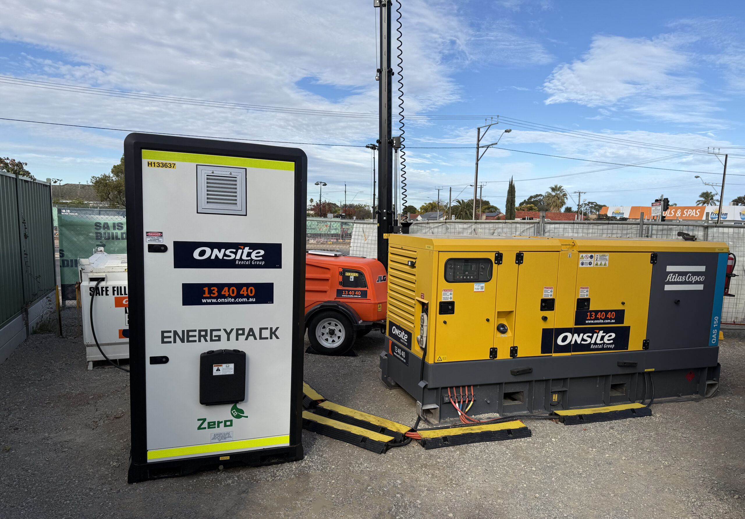 A large Onsite energy pack connected to a generator running on a building site