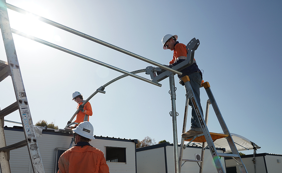 Onsite employees setting up hired solar panels