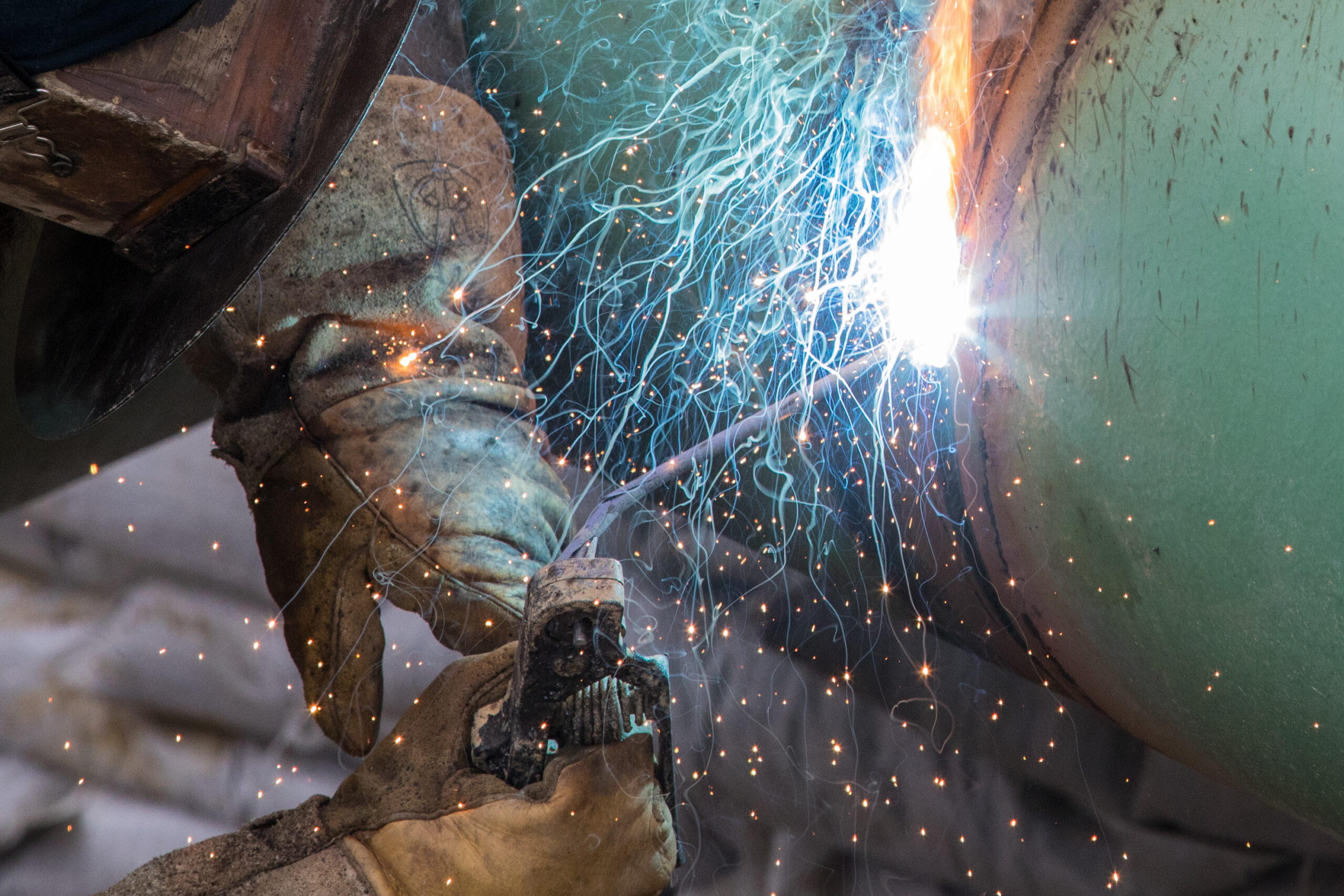 Welder making a tie-in weld into a pipeline.